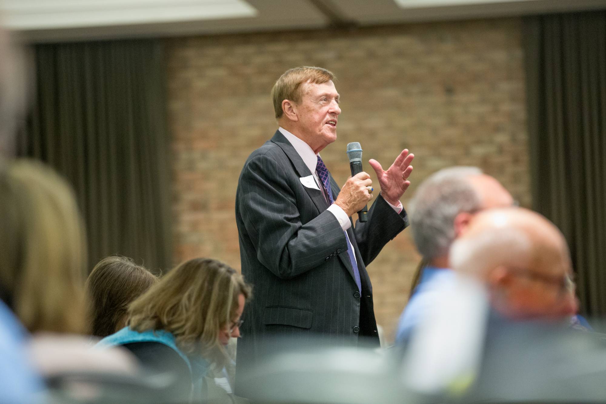 Man asking question through a microphone